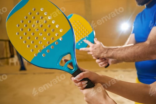 Preview: Man and woman are holding beach tennis racket