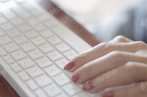 Preview: Close-up view woman hands typing on white keyboard