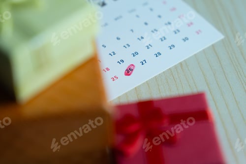 Preview: Close-up of a calendar with the 26th date circled in red surrounded by colorful gift boxes.