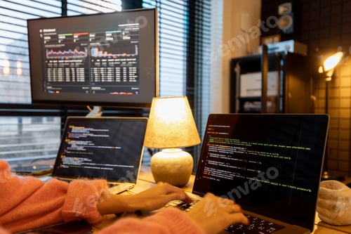 Preview: Female programmer writing programming code at cozy home workplace