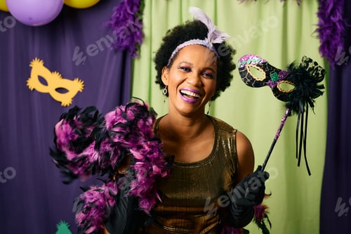 Preview: Cheerful African American woman having fun on Mardi Gras celebration event.