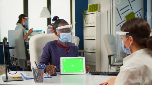 Preview: Black woman showing to manager tablet with green screen