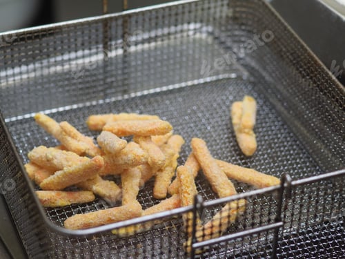 Preview: chef deep fying in boiling oil potato chips and snacks in hotle kitchen