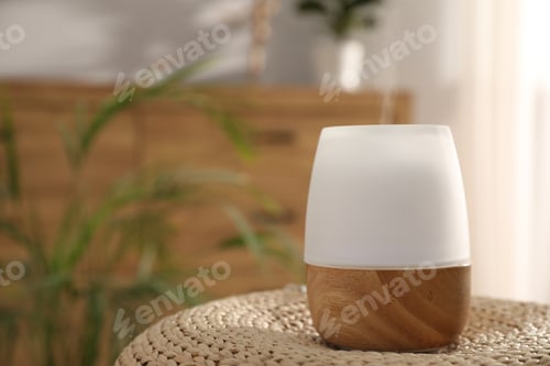 Preview: Modern aroma lamp on wicker surface indoors. Space for text