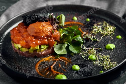 Preview: Salmon tartare with avocado on a dark plate, Traditional Italian cuisine, dish on a dark background