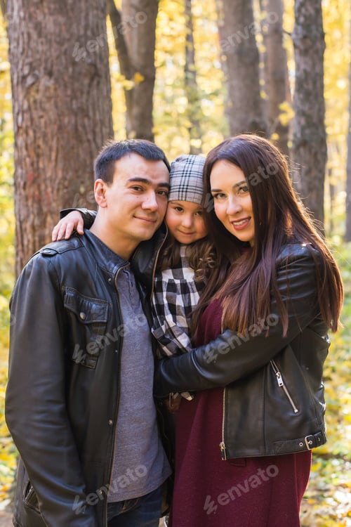 Preview: Family, fall, people concept - mixed race young family walking in park on in autumn day