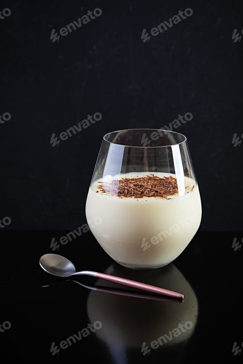 Preview: Sweet milk pudding with almonds and chocolate chips isolated on dark background