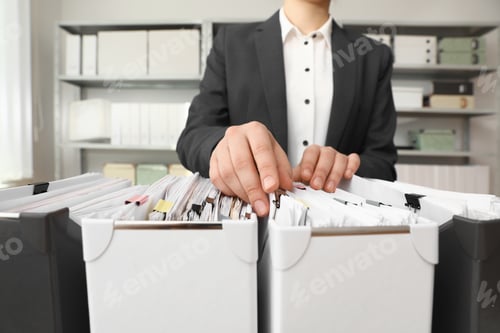 Preview: Woman taking documents from folder in archive, closeup