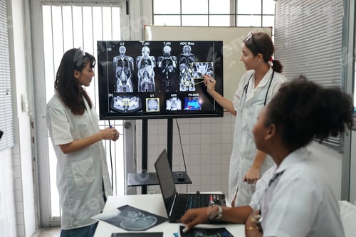 Preview: Group of doctors looking at X-ray on medical conference, discussing issues