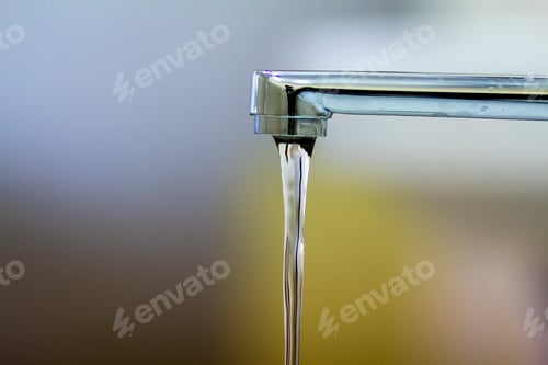 Preview: Close-up of faucet with turned drop water in modern bathroom.