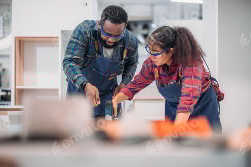 Preview: Experienced carpenter expertly drills precise holes, crafting furniture with practiced skill