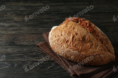 Preview: Towel with fresh baked bread on wooden table