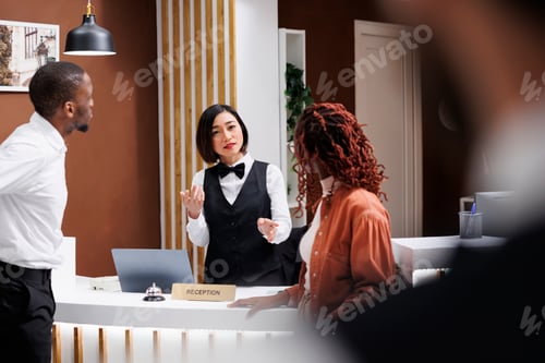 Preview: Worker talking to couple at reception