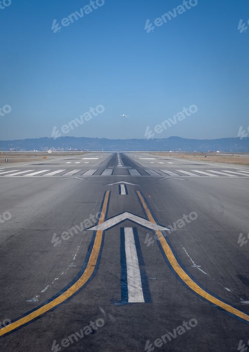 Preview: Airport runway with airplane taking off.