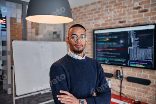 Preview: Startup Leadership: African American Businessman in Modern Office with Colleagues in Background.