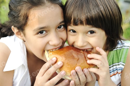 Preview: Closeup Of Two Children Eating Sandwich In Nature Together, Healthy Food, Care And Love