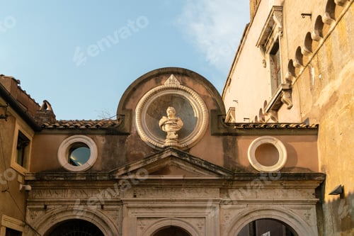 Preview: Golden sunset light kisses the facade of an ancient building with classical sculptures.