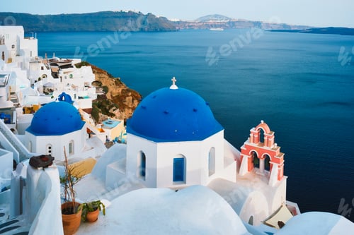 Preview: Famous view from viewpoint of Santorini Oia village with blue dome of greek orthodox Christian