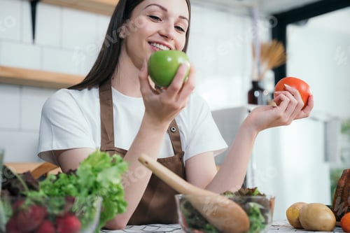 Preview: woman cooking healthy food from fresh vegetables and fruits in kitchen room.