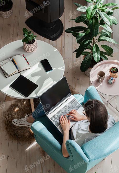 Preview: Young woman using laptop to work home, remote work
