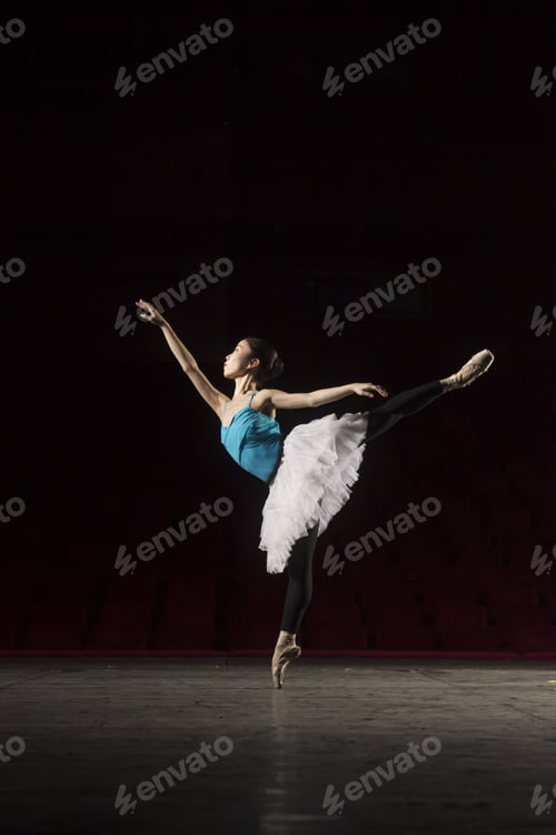 Preview: One Ballerina Practising On Stage. Standing On One Leg.