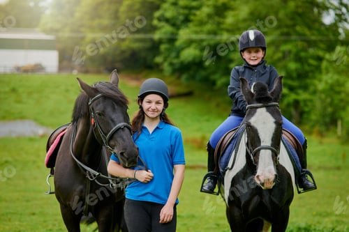 Preview: If you climb into the saddle be ready for the ride. Shot of young girls and their horses outdoors.