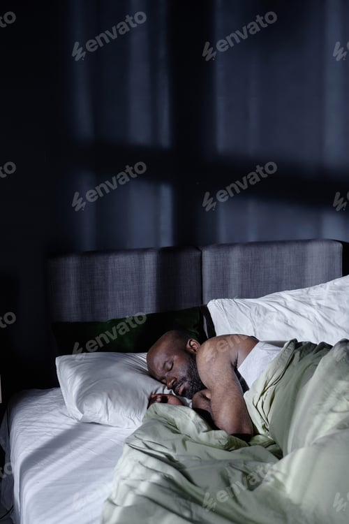 Man Sleeping Peacefully in Bed at Home