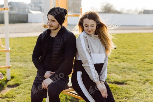 Preview: Young Woman and Man Sitting Outside