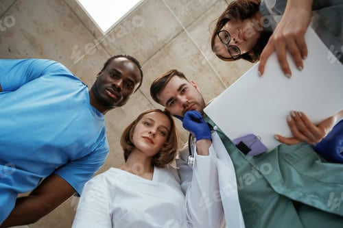 Preview: Conception of curiosity. View from below of group of doctors