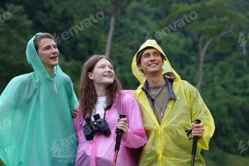Preview: Hikers walking along a trail on a mountain with hiking sticks