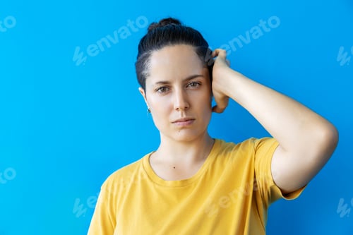 Preview: Authentic young woman with minimalist style and serious expression