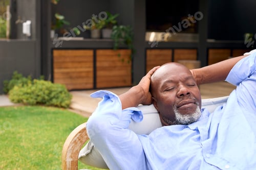 Preview: Senior Man Sleeping On Outdoor Seat In Garden At Home