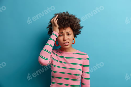 Preview: Unhealthy frustrated woman grimaces from pain, stress and tension, feels unwell, touches head and su
