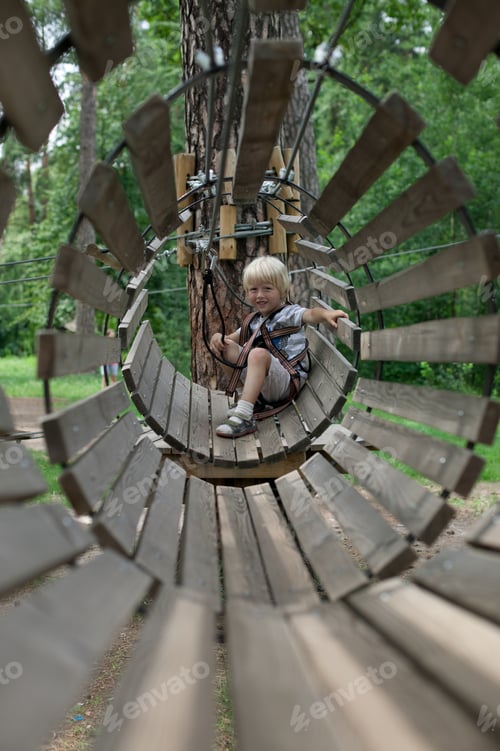 Preview: Boy in the summer in the tube in the amusement park in the rope park
