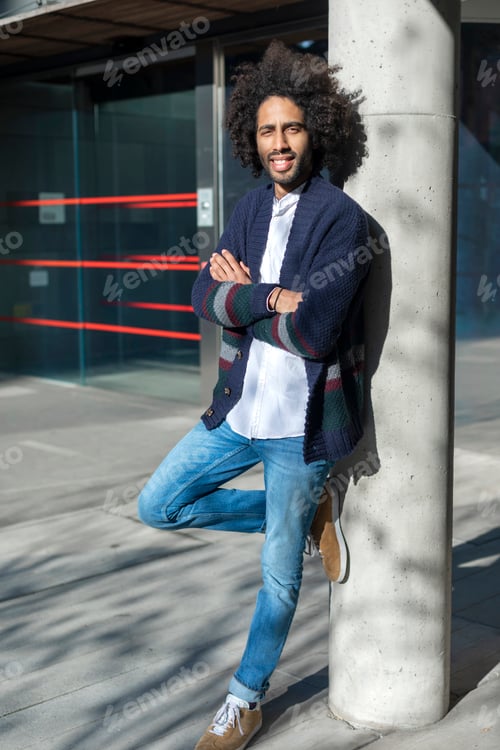 Preview: Young african american man smiling happy standing at the city