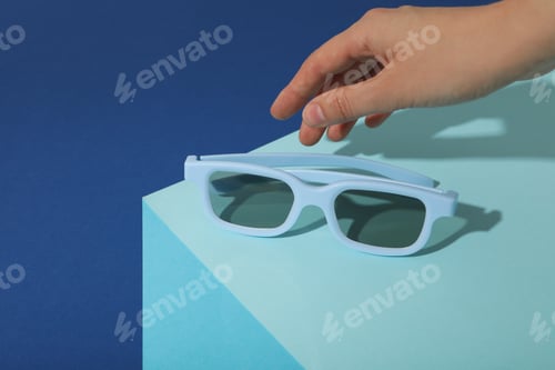 Preview: Sunglasses on a blue background, top view
