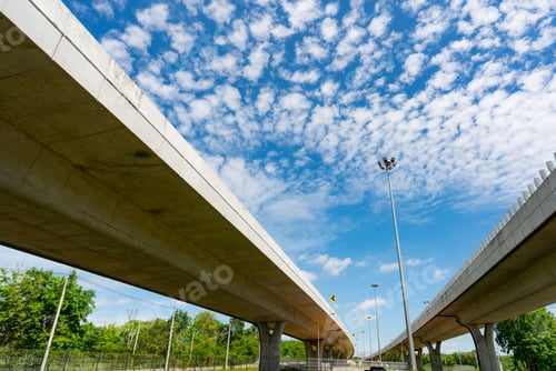 Preview: Bottom view of elevated concrete highway. Overpass concrete road. Strong structure of cement bridge