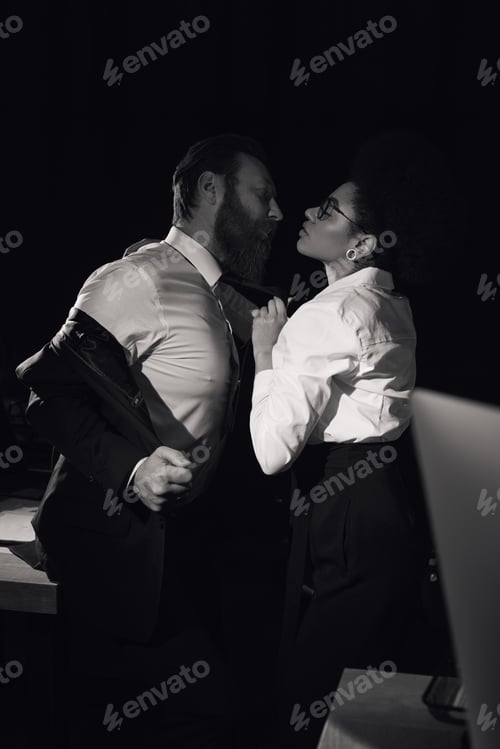 Preview: black and white image of passionate african american woman near bearded businessman, office romance