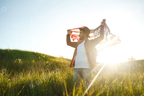 Preview: 4th of July. American Flag.Patriotic holiday. Traveler with flag of America. Beautiful sunset light.