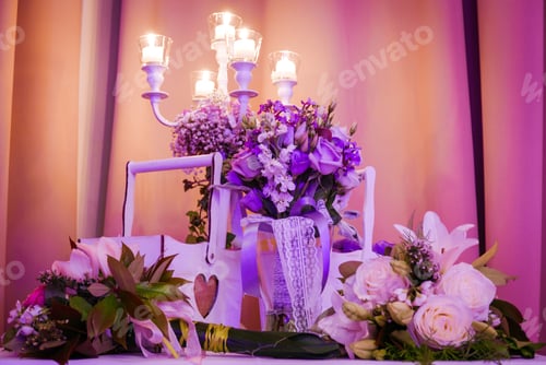 Preview: Close-up of wedding decorations and candles on table.