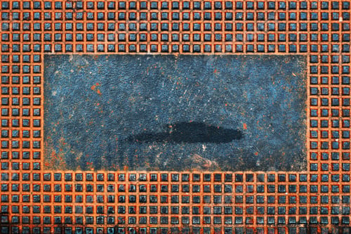 Preview: Rusty manhole cover with square shape pattern