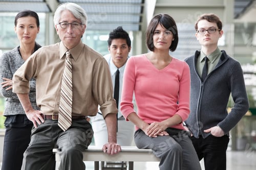 Preview: A team portrait of a mixed race group of business people with an Asian businessman in the lead.
