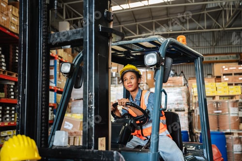 Preview: Portrait of a female worker with a forklift in the warehouse., Industrial and industrial concept.