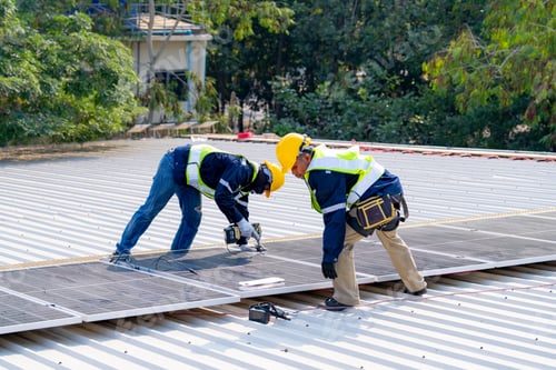 Preview: workers installing solar panels, for efficient energy on rooftop