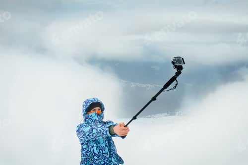 Preview: Man taking selfie at the mountain using action camera