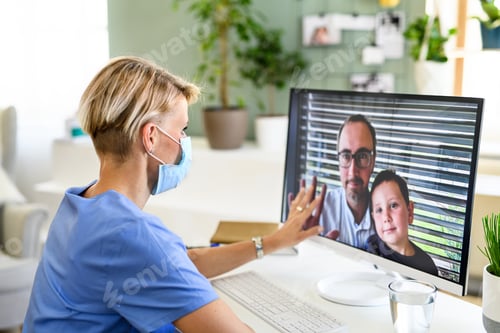 Preview: Woman doctor having video call with husband and son, social distancing concept