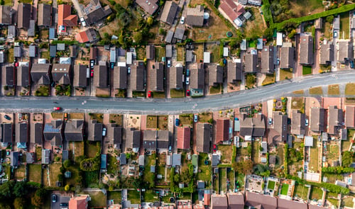 Preview: Aerial view directly above a road through a suburban housing estate