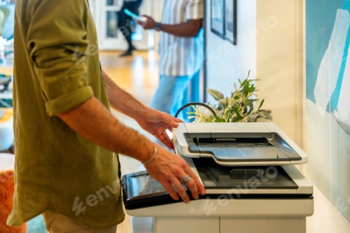 Preview: Coworker scanning document using office printer in a coworking space