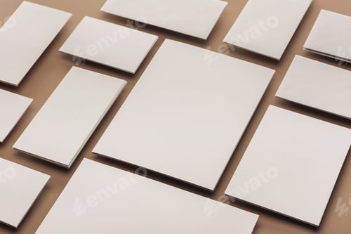 Preview: White cards and sheets of paper on beige background