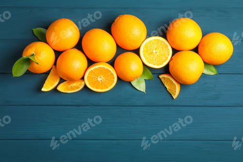 Preview: Flat lay composition with ripe oranges and leaves on wooden background. Top view, space for text